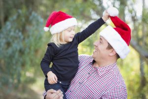 Dad and daughter with Santa hats