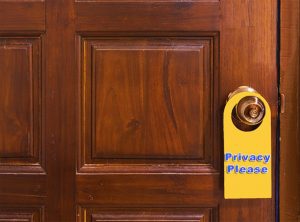 Door with "privacy please" sign